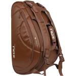 Brown backpack with multiple straps and zippers, shown from side view for rugged travel use.