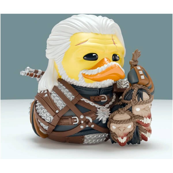 Action figure: a yellow duck knight in chainmail and brown leather armor, with white flowing hair and weapons visible nearby.